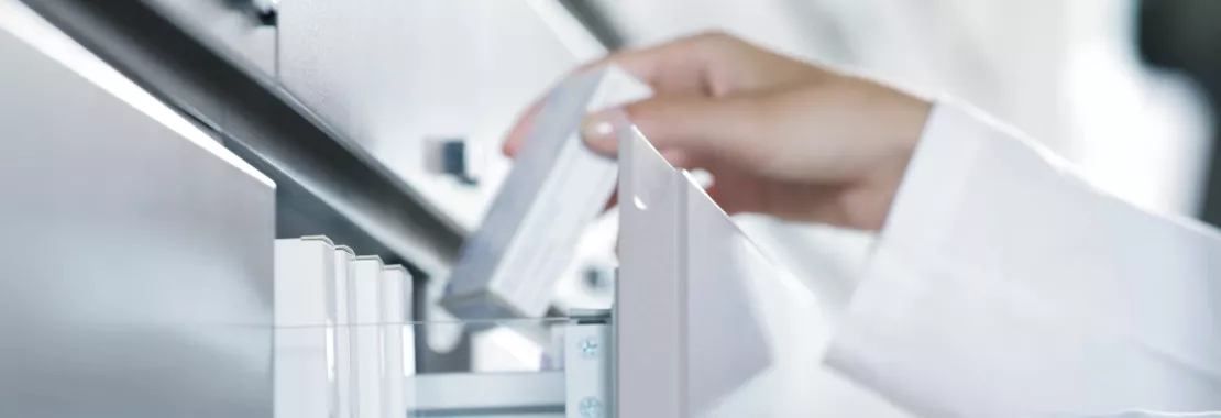 Person tacking medicine from a shelf